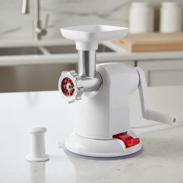 Close-up of Bellemain manual meat grinder with suction base and meat pusher.