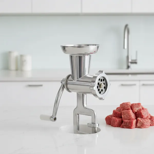 Sleek stainless steel manual meat grinder on a clean countertop, emphasizing modern design and hygiene.