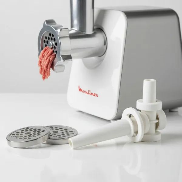 Close-up of Moulinex HV8 meat grinder accessories, including mincing grids, sausage, and kebbe attachments.